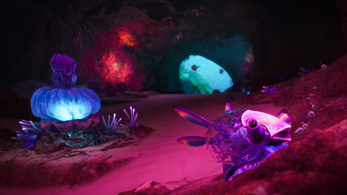 Glowing marine flora and fish in an underwater cave in ‘Subnautica 2’
