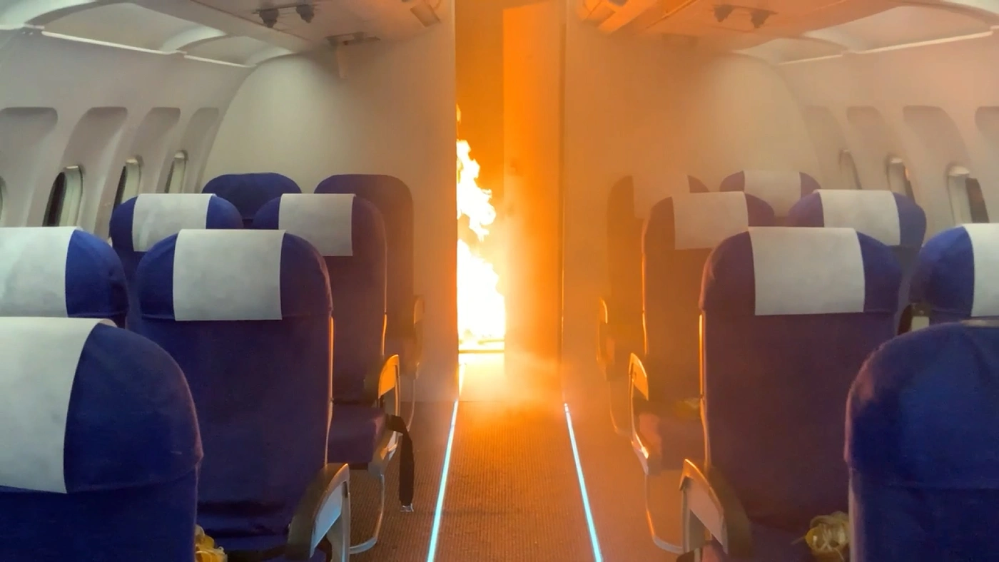 On-set shot of aeroplane cabin on fire.