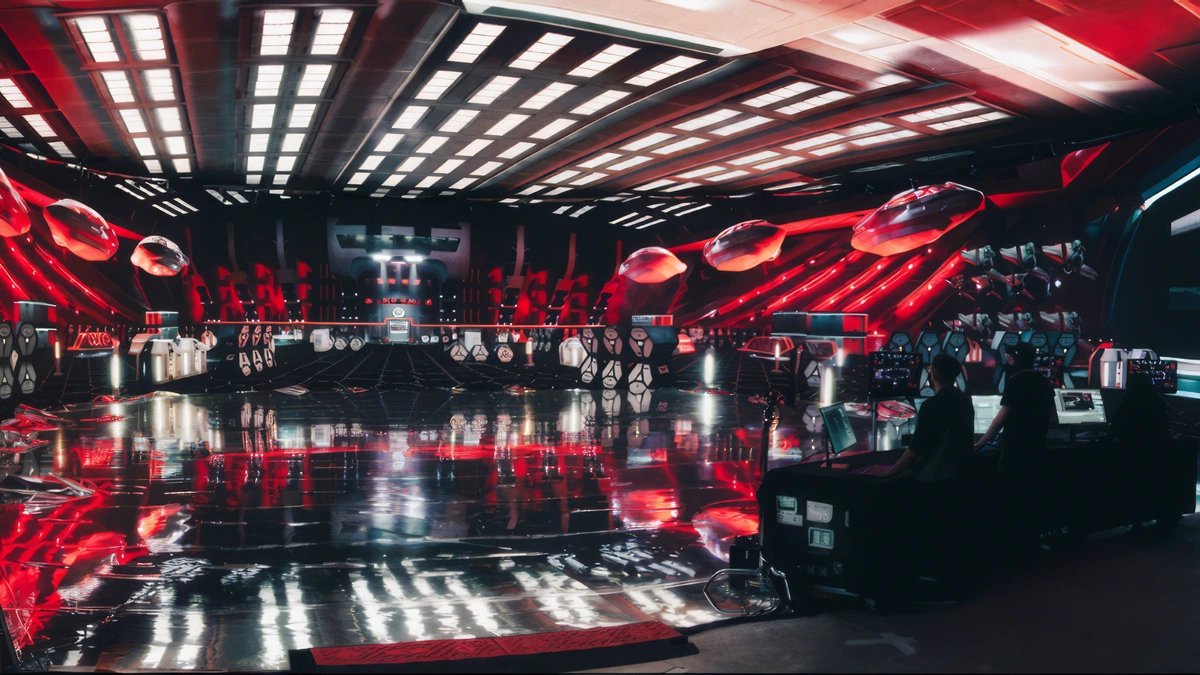 Futuristic virtual set with red and white lights augments practical reflective floor