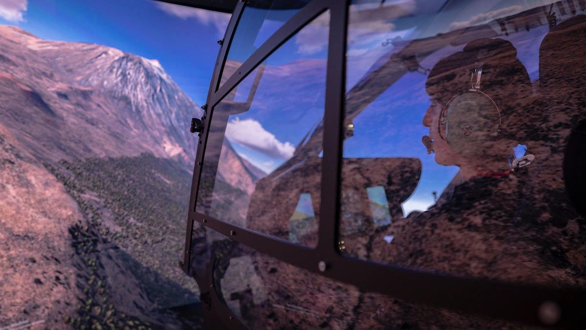 Side view of pilot, cockpit, mountains, and sky in Entrol ENVISION.