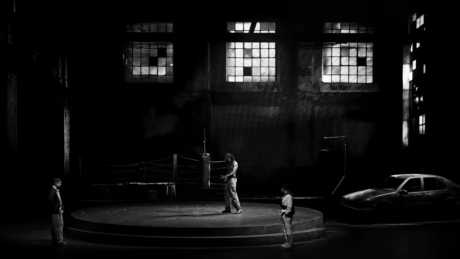 Black and white stage shot of ‘La Haine: Jusqu’ici rien n’a changé’.