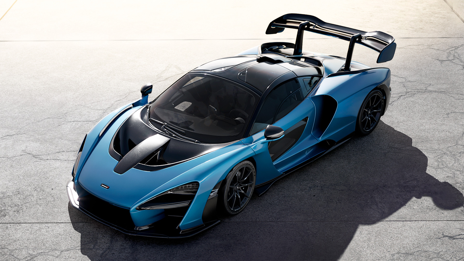 A CG rendering of a blue McLaren supercar, created by Renderoom.