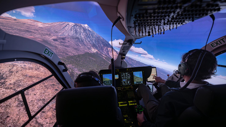 Pilots in cockpit with view of 3D mountains in Entrol ENVISION.