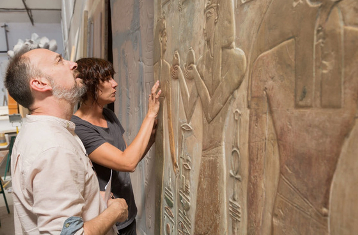 Conservators inspect the facsimile of the tomb.